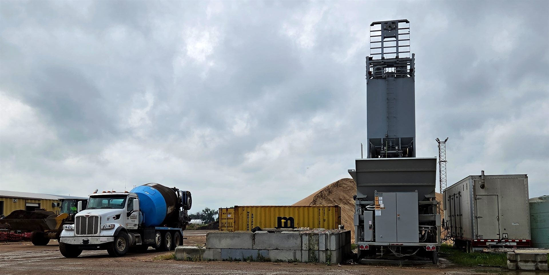 A JD Concrete portable batch plant and a mixer truck